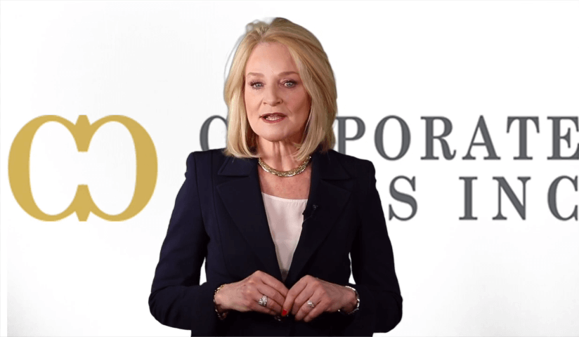 Diane standing in front of the Corporate Class Logo and Company name from the background.
